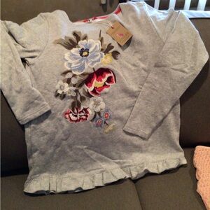 Joules sweatshirt with embroidered front and ruffle hem.